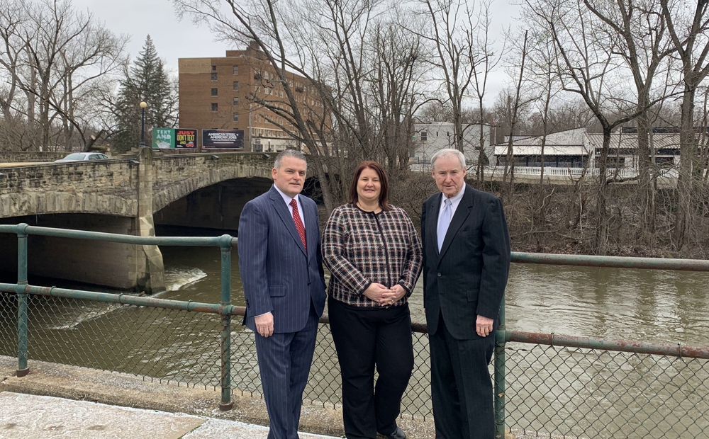 HHM lawyers Kevin Murphy, Shawna L'Italien and Paul Dutton say the report covers the firm's support for a wide variety of organizations in the tri-county area, including its support for the Fund for Warren's Future, which involves revitalizing the city and improving its image. The riverfront behind them is a focal point for the redevelopment fund. 